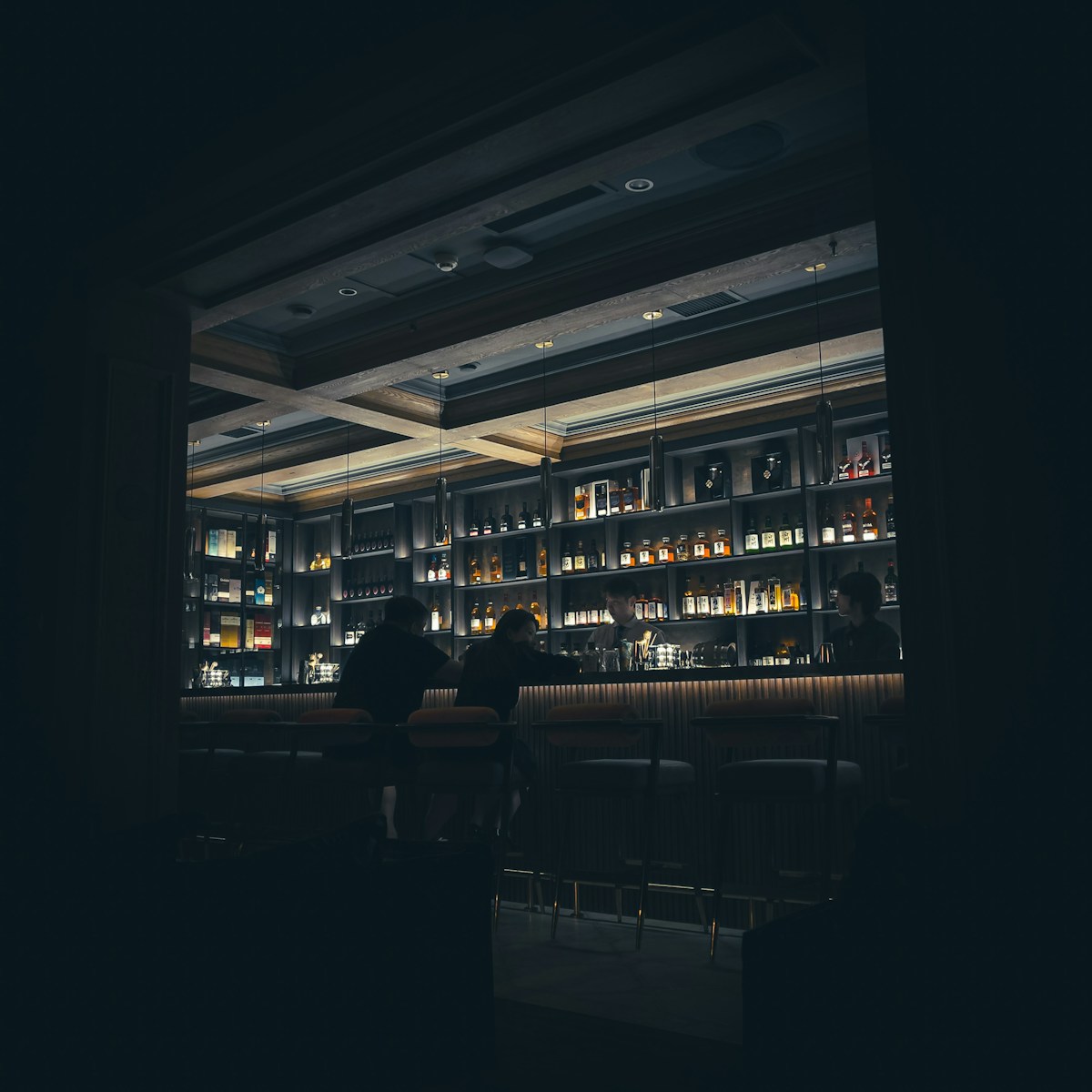 a person sitting at a table in a dimly lit room